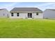 Well-kept backyard with lush green grass, patio, and view of the home's rear exterior at 100 Haddonfield Ct, Franklinton, NC 27525