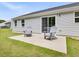 Exterior patio with two chairs, and fenced backyard, with vinyl siding on the home at 100 Haddonfield Ct, Franklinton, NC 27525