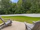 A well maintained backyard featuring a privacy fence, grass, and patio with chairs at 100 Haddonfield Ct, Franklinton, NC 27525