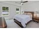 Bright bedroom with neutral colors, large windows, ceiling fan, and modern wood furniture at 100 Haddonfield Ct, Franklinton, NC 27525