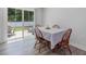 Bright dining area with view of patio and backyard featuring wood chairs and a glass door for light at 100 Haddonfield Ct, Franklinton, NC 27525