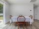 Cozy dining area with wood table and chairs with light gray walls and a glass door for natural light at 100 Haddonfield Ct, Franklinton, NC 27525