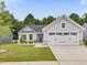 Charming single-story home with gray siding, a two-car garage, and a well-manicured lawn at 100 Haddonfield Ct, Franklinton, NC 27525