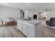 Spacious, open-concept living area with white cabinets, an island, and hardwood floors at 100 Haddonfield Ct, Franklinton, NC 27525