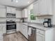 Bright kitchen featuring stainless steel appliances and granite countertops at 100 Haddonfield Ct, Franklinton, NC 27525
