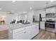 Bright kitchen featuring granite counters, stainless appliances, and an island overlooking the living room at 100 Haddonfield Ct, Franklinton, NC 27525