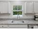 Granite countertops and stainless steel sink in modern kitchen at 100 Haddonfield Ct, Franklinton, NC 27525