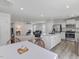 Open-concept living area featuring a spacious kitchen with white cabinets and stainless steel appliances at 100 Haddonfield Ct, Franklinton, NC 27525