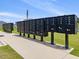 Community mailboxes with multiple units, standing in a row, near a sidewalk and green space at 100 Haddonfield Ct, Franklinton, NC 27525