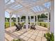 Shaded community pergola provides a relaxing outdoor space with seating and views of nearby homes at 100 Haddonfield Ct, Franklinton, NC 27525