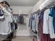 Organized walk-in closet offers ample hanging and storage space with shelving and neutral decor at 100 Haddonfield Ct, Franklinton, NC 27525