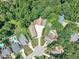 Aerial view of a residential neighborhood featuring manicured lawns, mature trees, and detached garages at 101 Ferndale Ct, Clayton, NC 27520