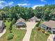 Aerial view of a home featuring manicured landscaping, mature trees, and a detached two-car garage at 101 Ferndale Ct, Clayton, NC 27520