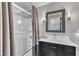 Modern bathroom with framed mirror, vanity, and shower with glass door and neutral shower curtain at 101 Ferndale Ct, Clayton, NC 27520