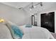Well-lit bedroom featuring black closet doors, track lighting, and vaulted ceilings at 101 Ferndale Ct, Clayton, NC 27520