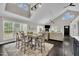 Open-concept dining area with table, chairs, and a view into the light and bright living room at 101 Ferndale Ct, Clayton, NC 27520