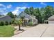Charming home with a well-manicured lawn, a wide driveway, and mature trees creating a serene backyard setting at 101 Ferndale Ct, Clayton, NC 27520