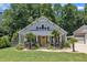 Charming home featuring a yellow front door, landscaped yard, and a well-manicured lawn and beautiful trees at 101 Ferndale Ct, Clayton, NC 27520
