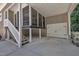 Spacious covered area with an attached garage, white stairs, and a garage door at 101 Ferndale Ct, Clayton, NC 27520