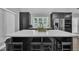 Modern kitchen with stainless steel appliances, dark cabinets, and a large island with seating at 101 Ferndale Ct, Clayton, NC 27520