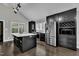 Modern kitchen with a large island, stainless steel appliances, dark cabinetry, and stylish lighting at 101 Ferndale Ct, Clayton, NC 27520