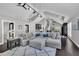 Cozy living room with high ceilings, a stylish sectional sofa, and contemporary lighting fixtures at 101 Ferndale Ct, Clayton, NC 27520