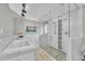 Spa-like main bathroom with a large soaking tub, walk-in shower, and elegant marble finishes at 101 Ferndale Ct, Clayton, NC 27520