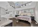 Large main bedroom with vaulted ceilings, hardwood floors, a luxurious bathroom, and modern lighting at 101 Ferndale Ct, Clayton, NC 27520