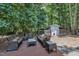 Outdoor seating with furniture and patio are great for outdoor entertaining in this wooded backyard at 101 Ferndale Ct, Clayton, NC 27520