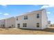 View of home's vinyl sided backyard with a sliding glass door and new lawn installation at 102 Leven Dr, Gibsonville, NC 27249