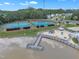 Aerial view of lake amenities featuring tennis courts, playground, and pier at 103 Bermuda Green Dr, Durham, NC 27703