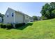 A spacious backyard with a lush green lawn and mature trees at 103 Bermuda Green Dr, Durham, NC 27703