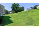 A spacious backyard with a lush green lawn and mature trees at 103 Bermuda Green Dr, Durham, NC 27703