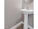 Well-lit bathroom featuring a pedestal sink and a neutral color palette at 103 Bermuda Green Dr, Durham, NC 27703