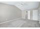 A spacious carpeted bedroom offers a ceiling fan and ensuite bathroom access at 103 Bermuda Green Dr, Durham, NC 27703