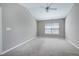 Spacious bedroom featuring carpeted floors, a ceiling fan, and a large window at 103 Bermuda Green Dr, Durham, NC 27703