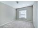This bedroom is equipped with plush carpet, neutral walls, and a large window at 103 Bermuda Green Dr, Durham, NC 27703