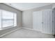 This bedroom is equipped with plush carpet, a window, and a closet at 103 Bermuda Green Dr, Durham, NC 27703