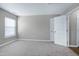 This bedroom is equipped with plush carpet, neutral walls, and a large window at 103 Bermuda Green Dr, Durham, NC 27703