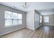 Charming entryway with hardwood floors, a chandelier, and natural light streaming in from the windows, offering a warm welcome at 103 Bermuda Green Dr, Durham, NC 27703