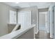 Upstairs hallway with wood floors, white trim, and closets at 103 Bermuda Green Dr, Durham, NC 27703