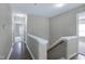 A neutral hallway with wood floors and a staircase at 103 Bermuda Green Dr, Durham, NC 27703