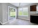 Sunny eat-in kitchen boasting sliding glass doors, tile floors, and easy access to the outdoor space at 103 Bermuda Green Dr, Durham, NC 27703