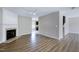 Open-concept living room with hardwood floors, fireplace, and a seamless transition to the adjacent room at 103 Bermuda Green Dr, Durham, NC 27703