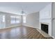 Bright living room with hardwood floors, fireplace, ceiling fan, and natural light, perfect for relaxing and entertaining at 103 Bermuda Green Dr, Durham, NC 27703