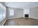 Comfortable living room with hardwood floors, fireplace, ceiling fan, and ample natural light, creating a cozy atmosphere at 103 Bermuda Green Dr, Durham, NC 27703