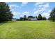 Sprawling backyard featuring an expansive green lawn and a storage shed for all your outdoor needs at 11 Sherman Rd, Fuquay Varina, NC 27526