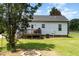 Backyard featuring a wooden deck, well-maintained siding, and a fire pit for cozy outdoor evenings at 11 Sherman Rd, Fuquay Varina, NC 27526