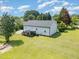 Exterior of home with a wooden deck overlooking a spacious, well-maintained backyard at 11 Sherman Rd, Fuquay Varina, NC 27526