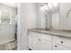 Bathroom featuring a granite countertop, white cabinets, and modern fixtures for a clean aesthetic at 11 Sherman Rd, Fuquay Varina, NC 27526